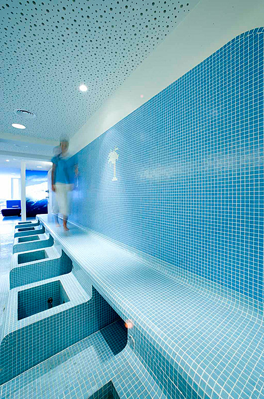 Lanserhof Health und Beauty Center, Innsbruck - Kneippzone mit Glasmosaiksteinen, Deckenspots, schimmernde Blautöne auf den Wänden - TROPP LIGHTING DESIGN